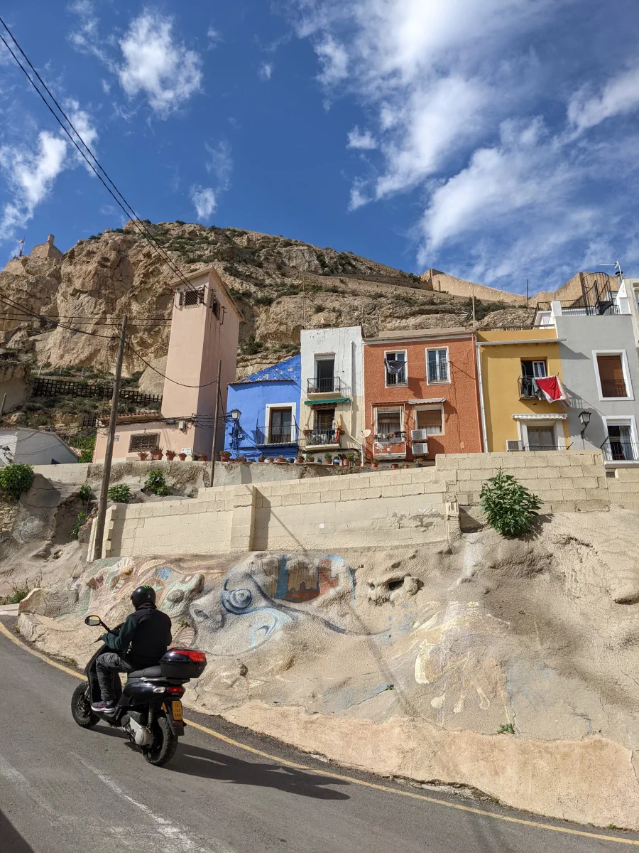 scooter driving by the old colourful houses