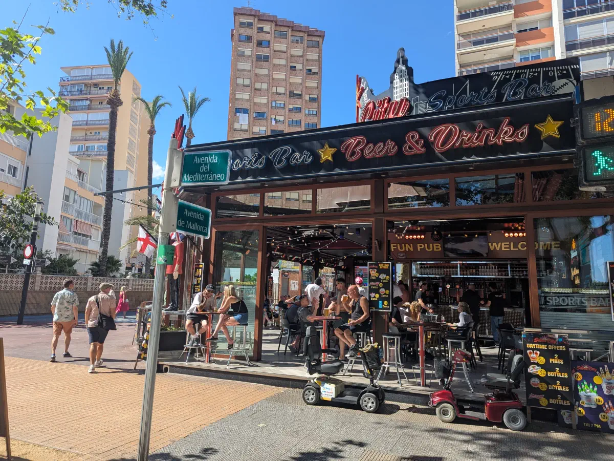 Benidorm bar area with electric trolleys in front.